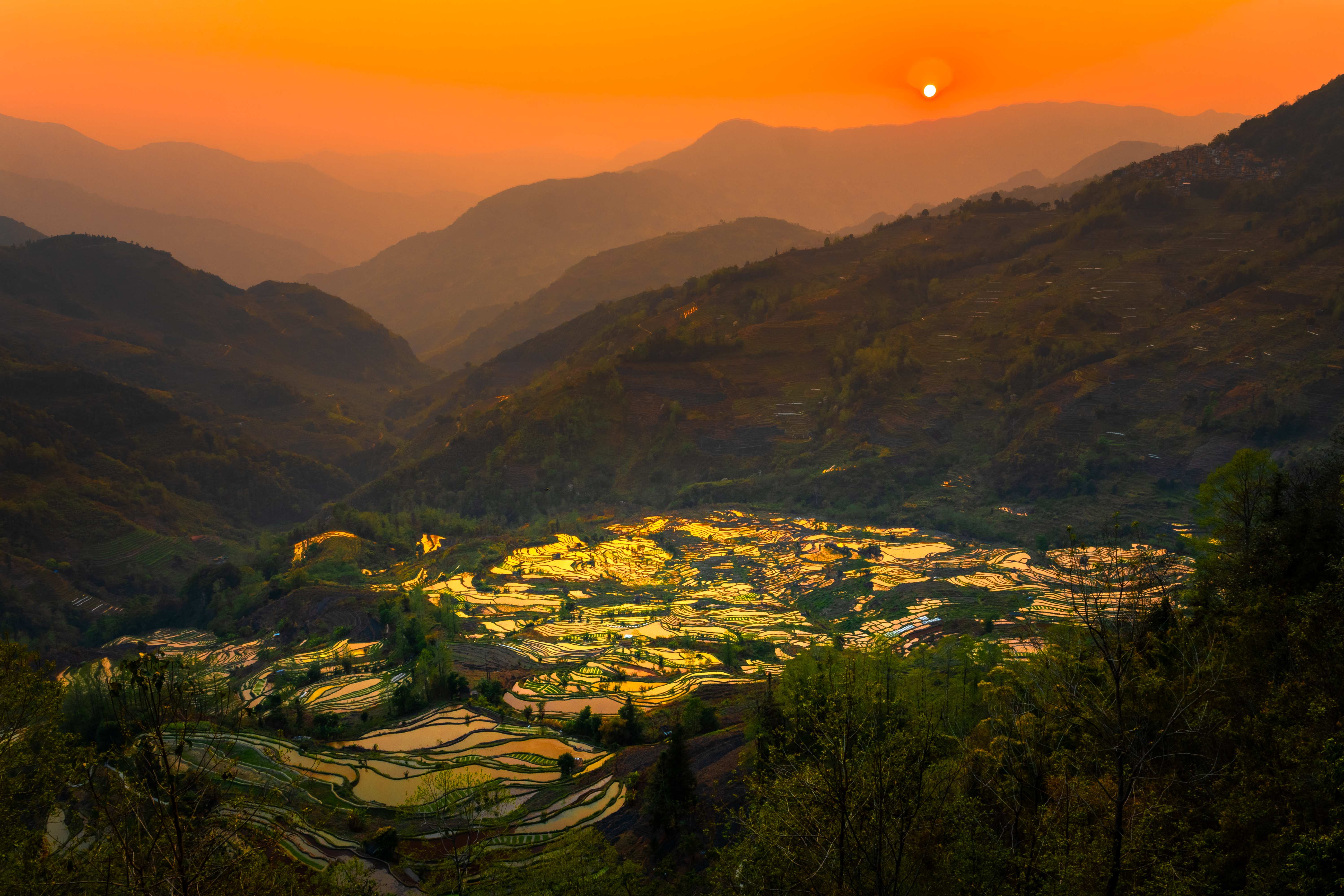 Rice terraces glowing in the valley at sunset
